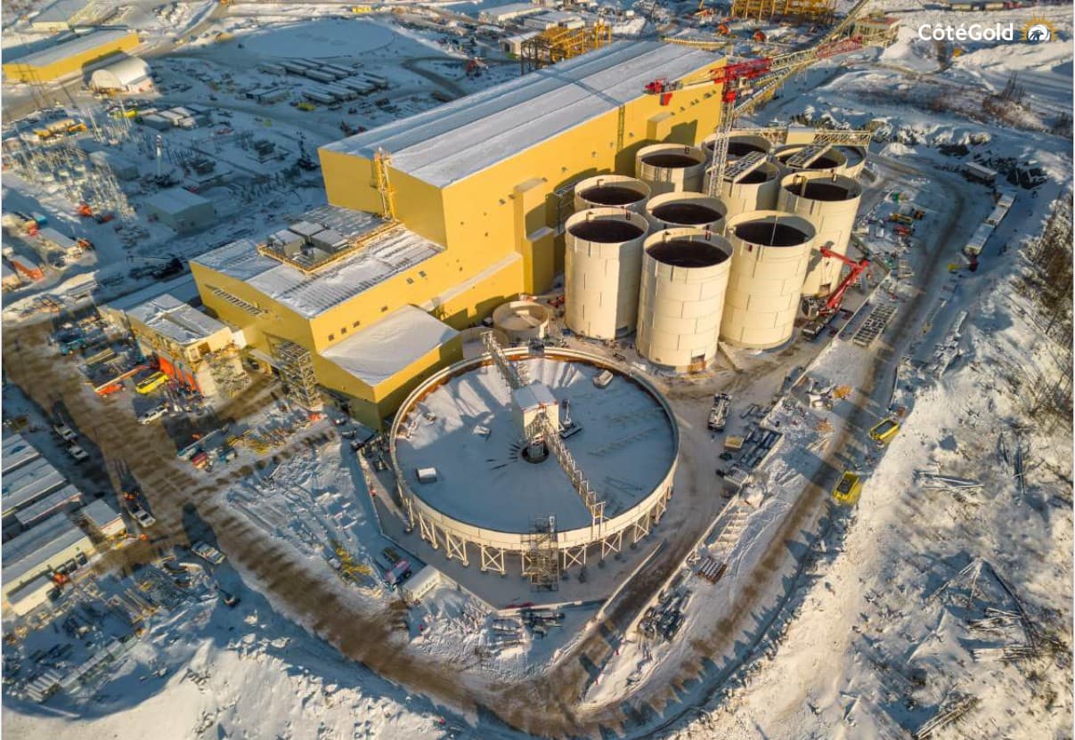 Aerial winter view of the Cote Gold processing plant under construction in Ontario, with the mill building, leach tanks and a large thickener